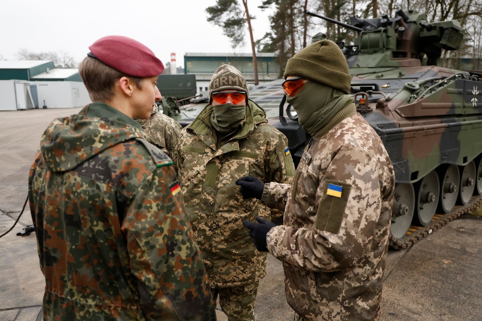 A German Bundeswehr Major speaks to members of the Ukrainian military who are learning to operate Leopard tanks and Marder infantry fighting vehicles during a press date at a training ground on February 20, 2023 in Munster, Germany. (Photo by Morris MacMatzen/Getty Images)