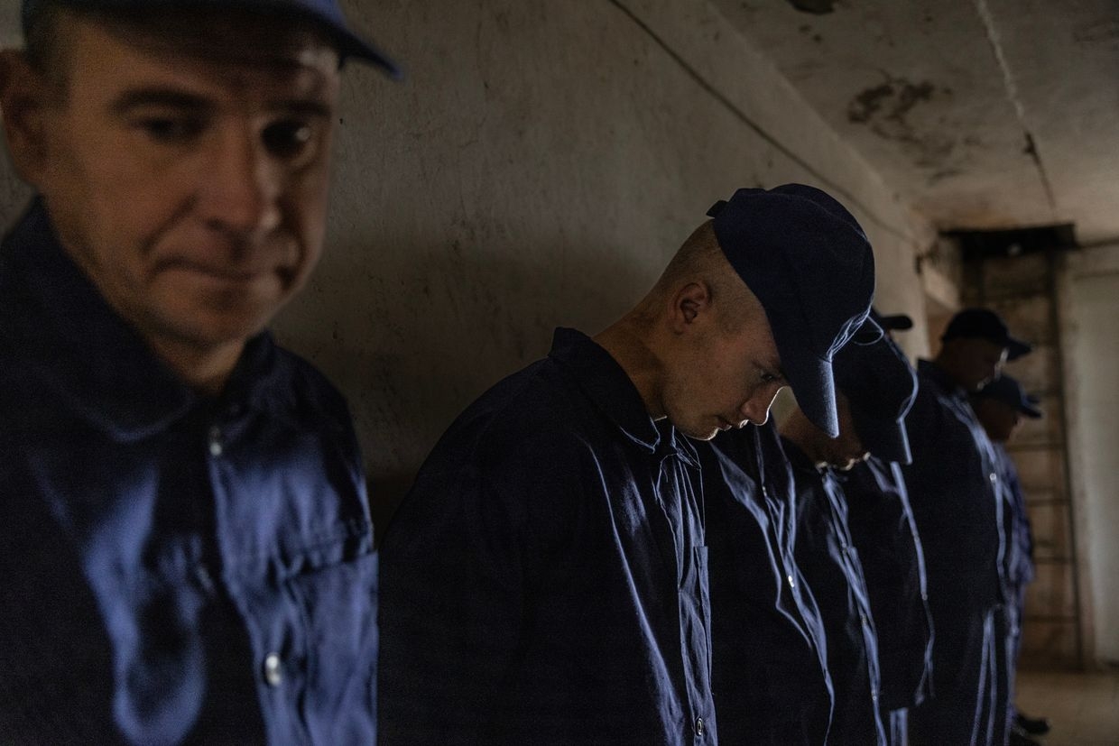Russian POWs wait in line to call home at a prisoner-of-war detention camp in Lviv Oblast, Ukraine, on Aug. 3, 2023.