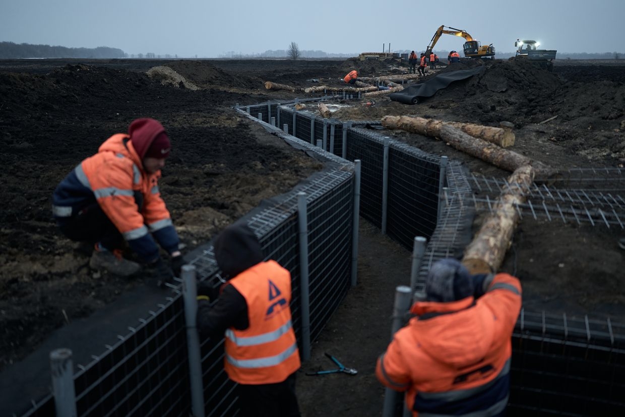 Representatives of the Regional Administration and the construction contractor Avtomagistral-pivden LLC inspect fortifications being built in the region in Sumy Oblast, Ukraine on March 16, 2024. 