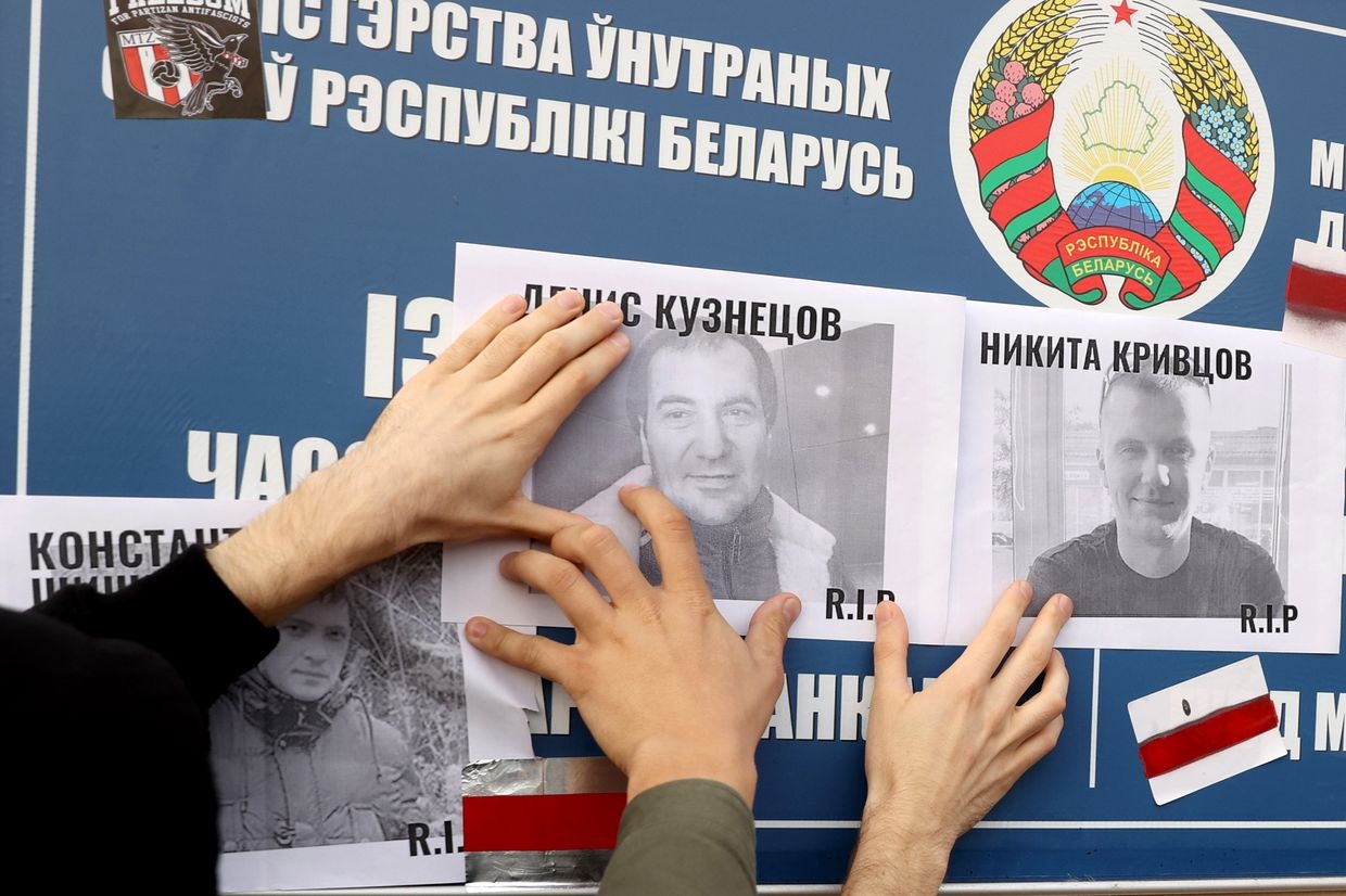 Demonstrators place photos of opposition supporters killed in post-election protests on Okrestina prison's wall in Minsk, Belarus, on Oct. 4, 2020.