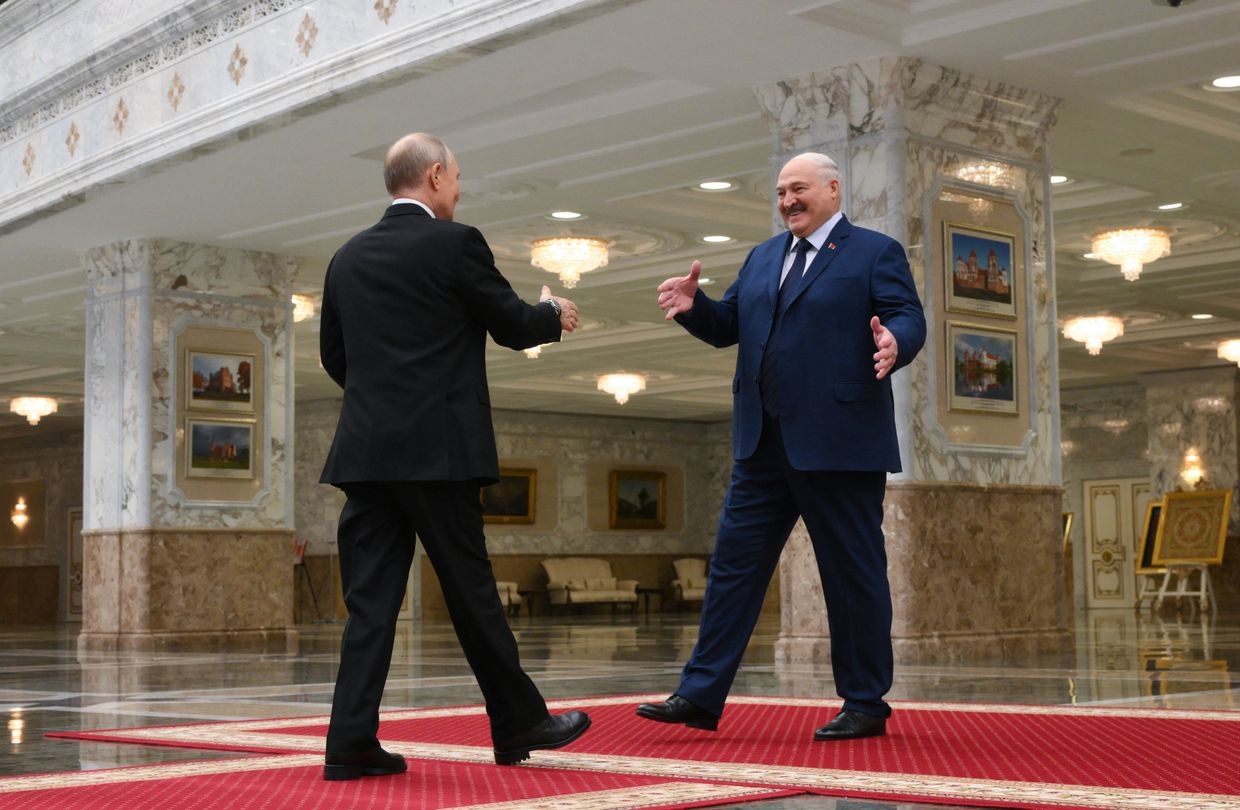In a Sputnik pool photo, Russia's Vladimir Putin and Belarus' Alexander Lukashenko shake hands before a Union State meeting in Minsk on Dec. 6, 2024.