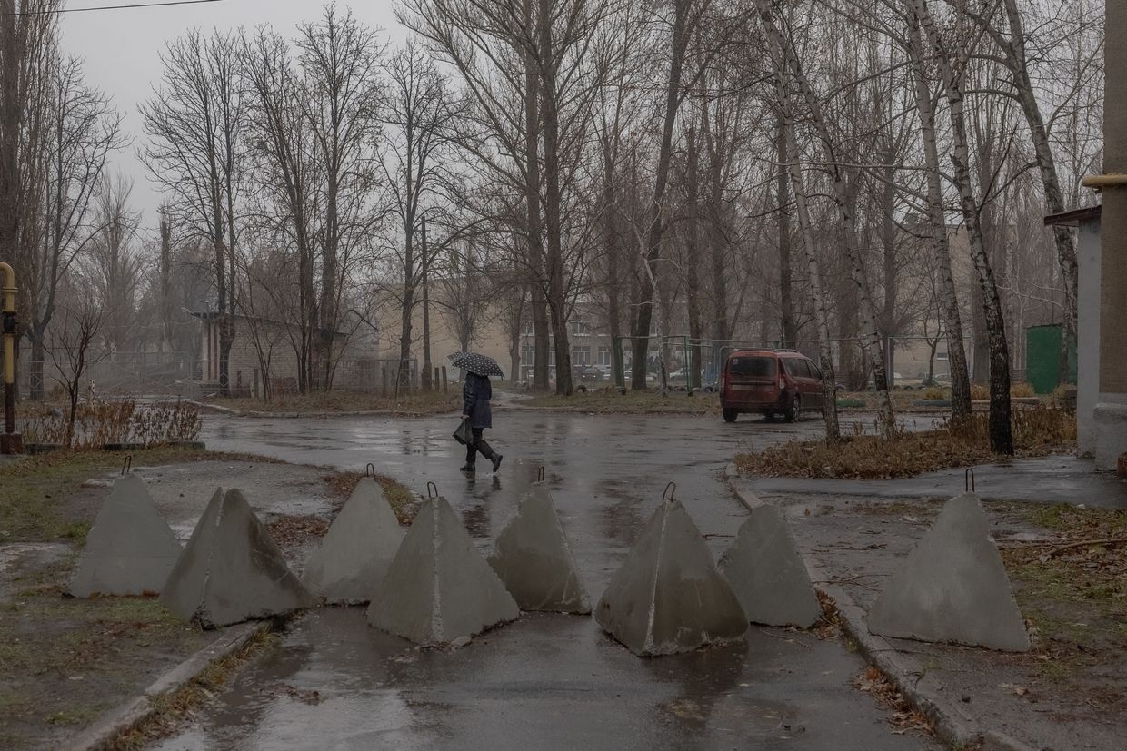  A resident walks past "dragon's teeth" fortifications set up by Ukraine's army in Pokrovsk, Donetsk Oblast, on Dec. 11, 2024.