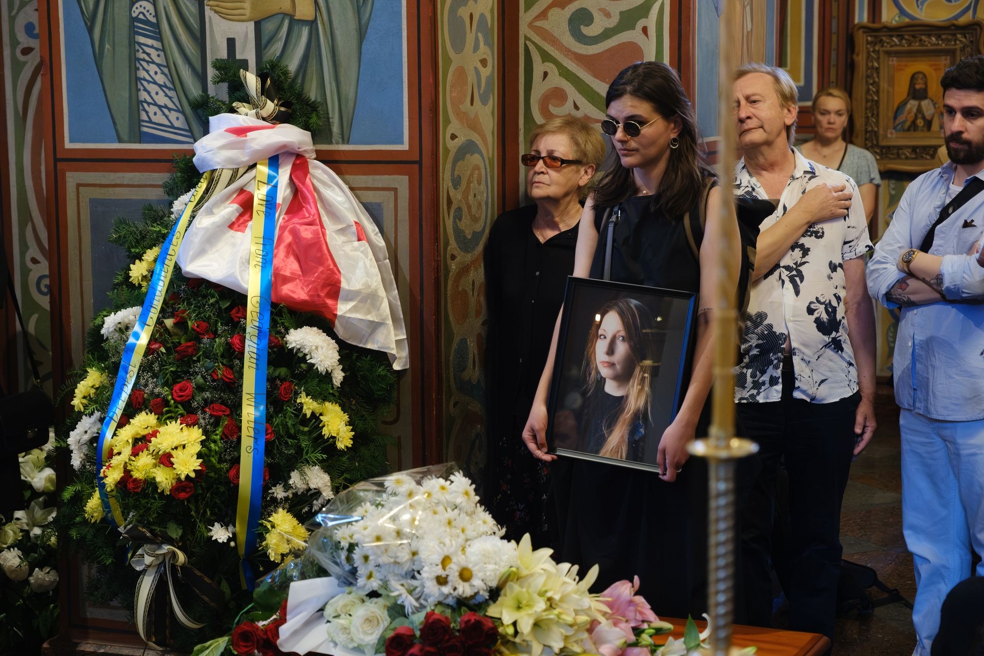 A woman in mourning holds a portrait of late Ukrainian author Victoria Amelina during a funeral ceremony at St. Michael’s Golden-Domed Monastery in Kyiv, Ukraine, on July 4, 2023.