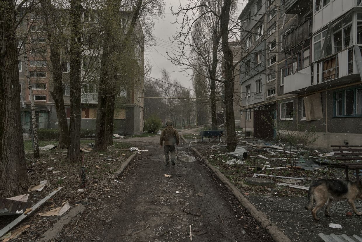 A soldier walks past destroyed residential buildings in Pokrovsk, Ukraine, on April 8, 2025. 
