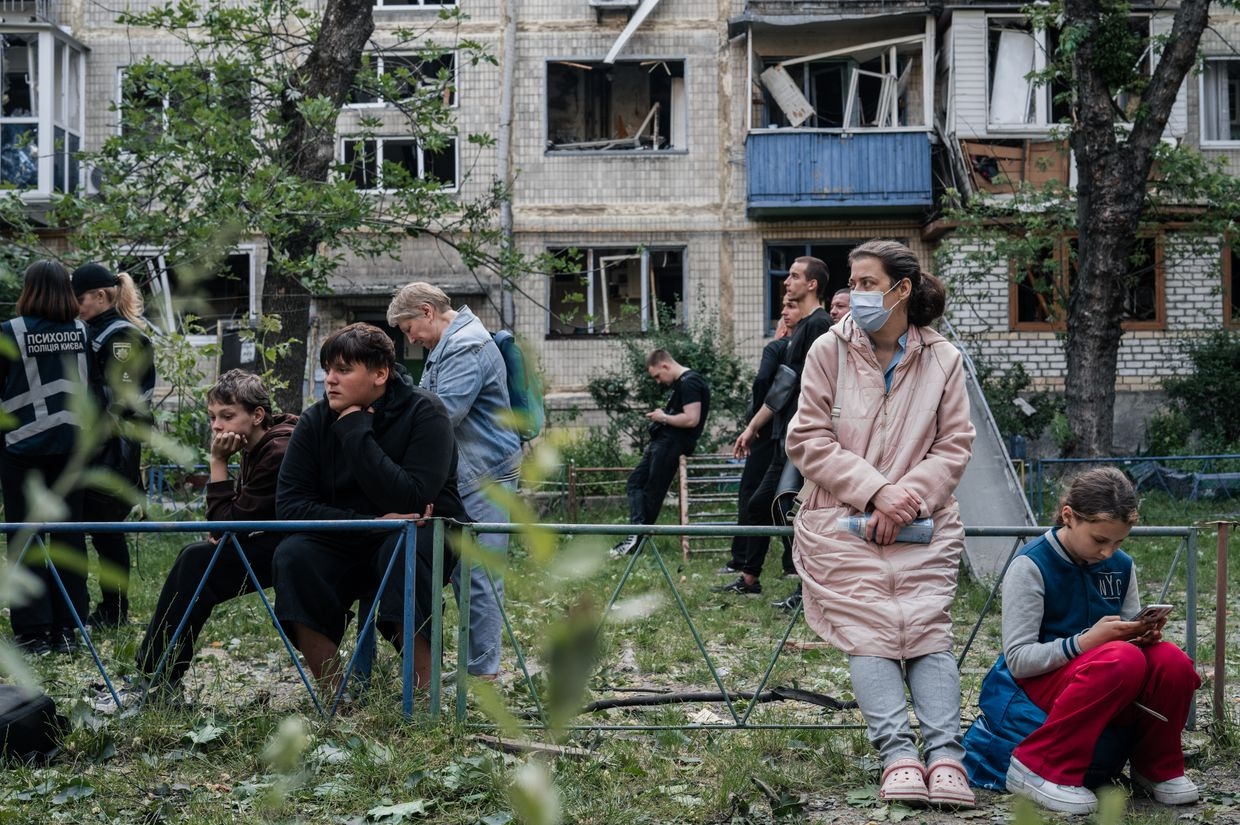 Residents evacuate a damaged apartment building after a Russian drone and missile attack in Kyiv, Ukraine, on June 17, 2025. 