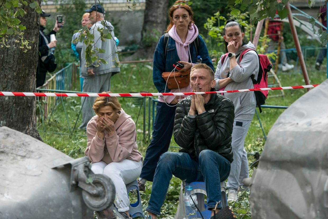 Family members of those still missing under the debris are at the site of a residential building hit by a Russian ballistic missile during a massive overnight attack in Kyiv, Ukraine, on June 17, 2025. 