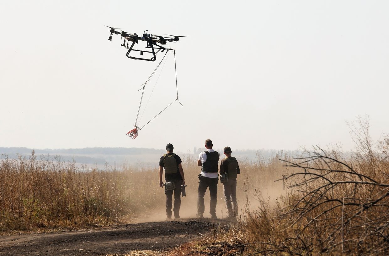 Representatives of the Postup NGO inspect a mined area with a drone as part of demining work in Kharkiv Oblast, Ukraine, on Oct. 1, 2023.