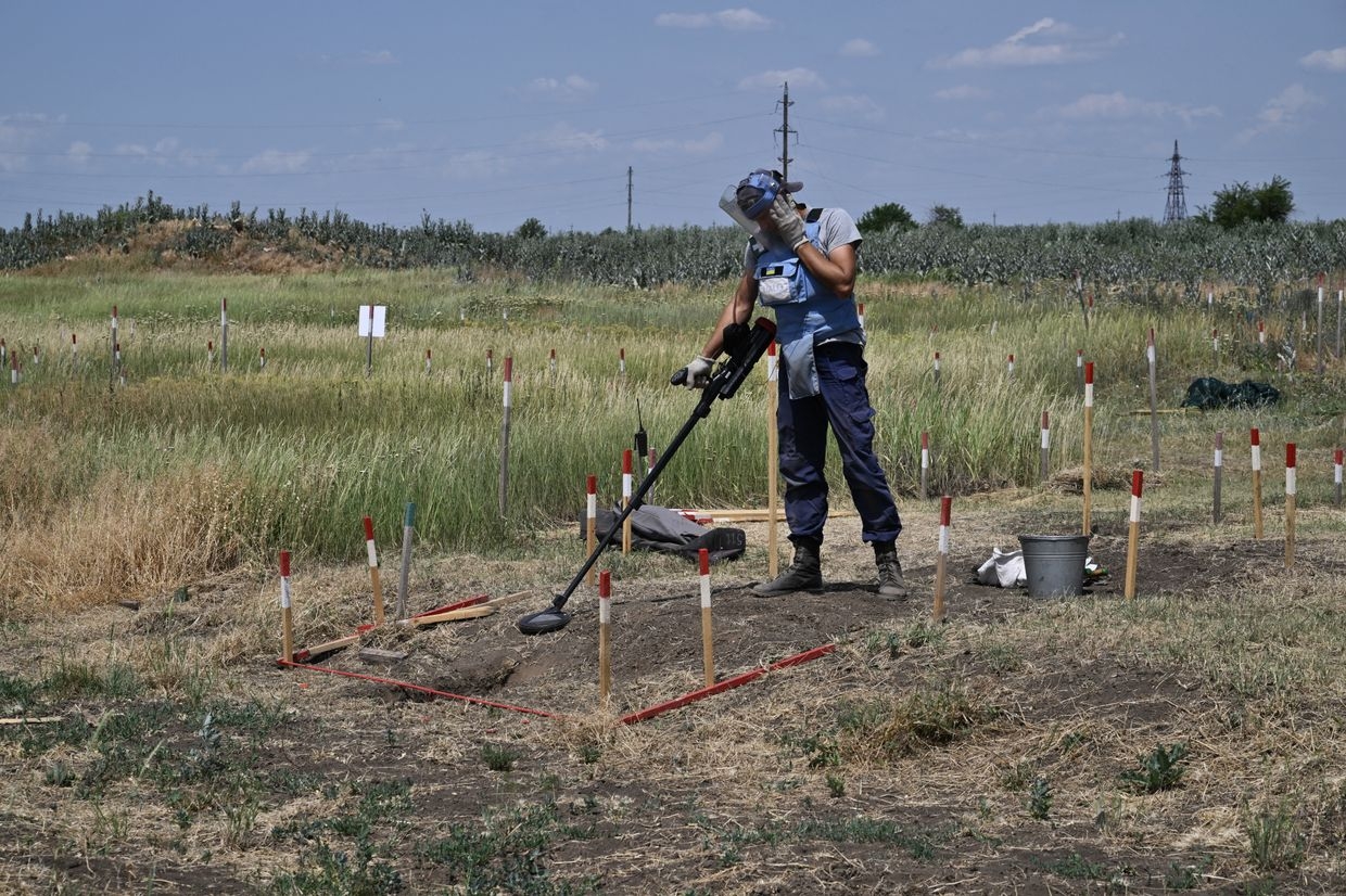 A deminer from the HALO Trust NGO clears mines in a field outside Snigurivka, Mykolaiv Oblast, Ukraine, on June 4, 2024. 