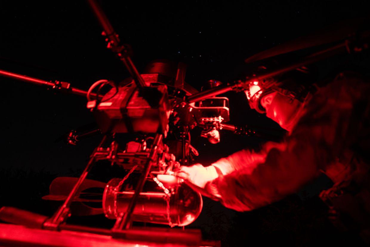 Call sign ‘Sonic,’ installs an 8-kilogram bomb on a heavy night drone, near Lyptsi, Ukraine, on June 19, 2024.