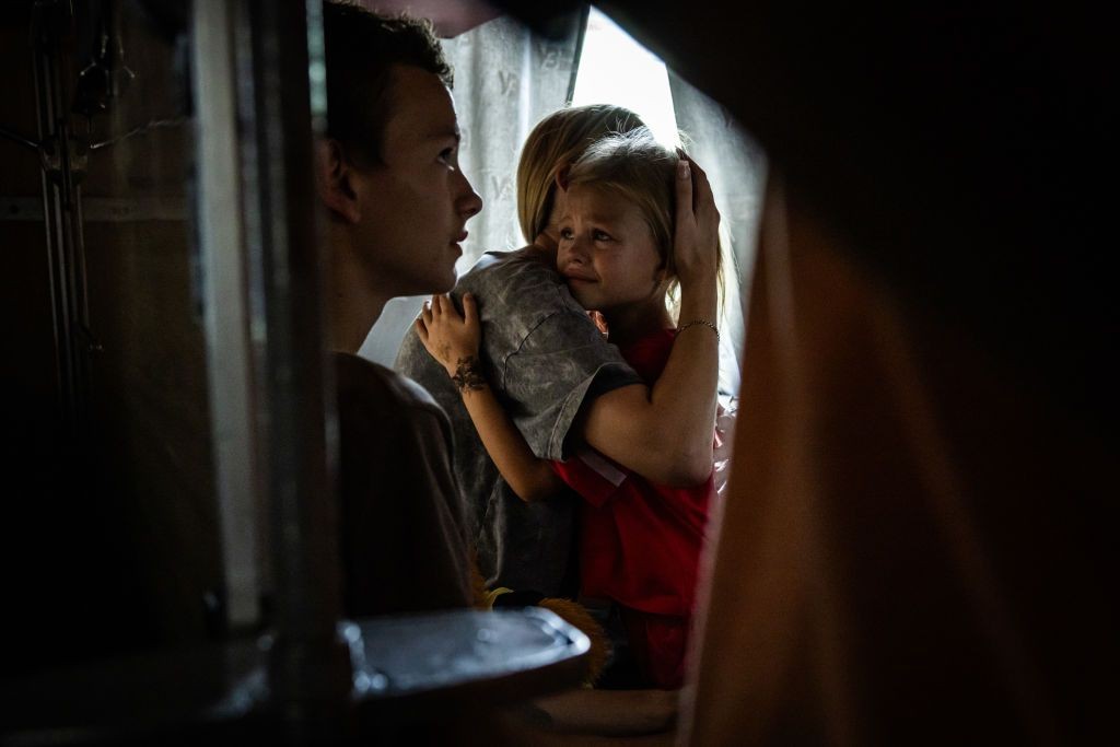 A child cries as they hug their mother in the evacuation train from Pokrovsk, Donetsk Oblast, Ukraine, on Aug. 2, 2024.