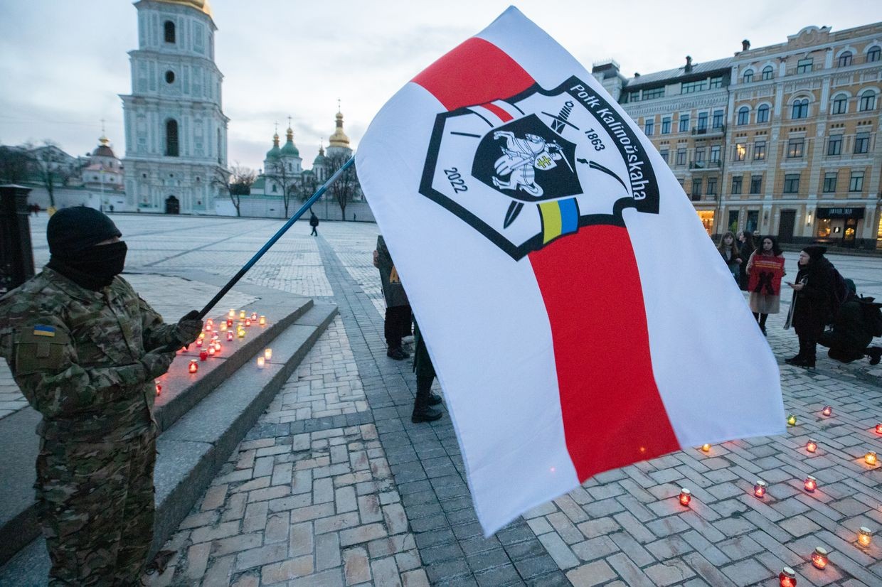Belarusian volunteers wave the Kalinouski Regiment flag during a protest in Sofia Square, Kyiv, Ukraine, on March 14, 2023.