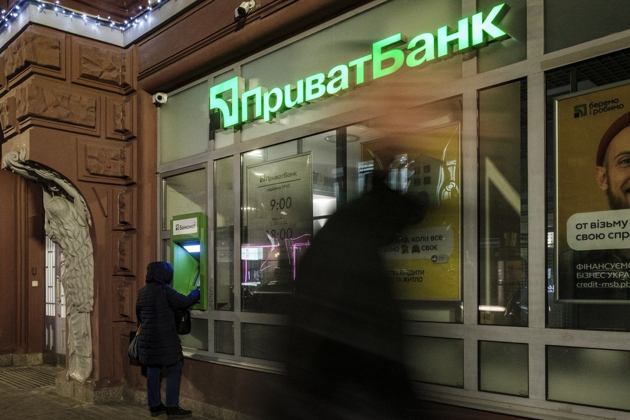A customer uses an ATM at a PrivatBank bank branch in Kyiv, Ukraine, on Feb. 22, 2022.