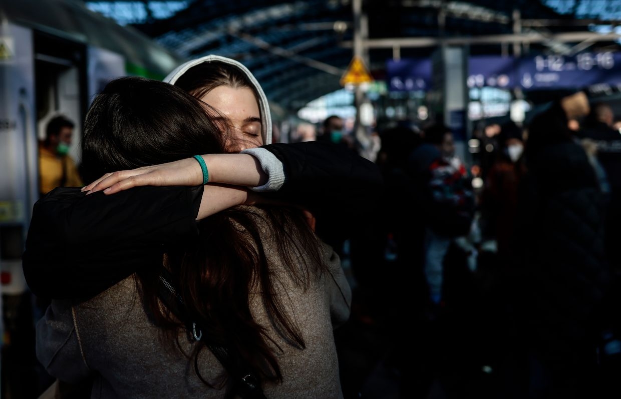 Two women hug each other after refugees from Ukraine arrive at the main train station in Berlin, Germany on March 1, 2022.
