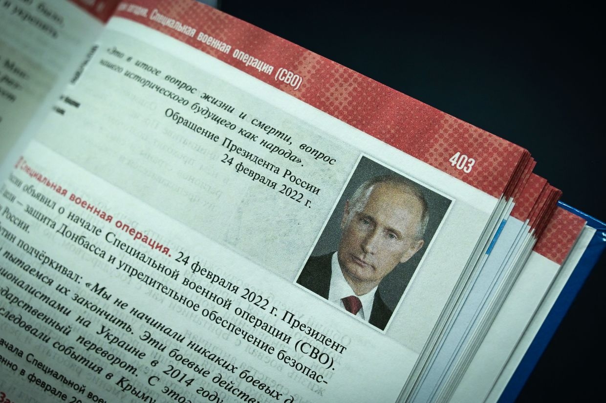 A portrait of Russia’s President Vladimir Putin is seen on a page of a schoolbook for high school students on world history and Russian history in Moscow, Russia, on Aug. 7, 2023