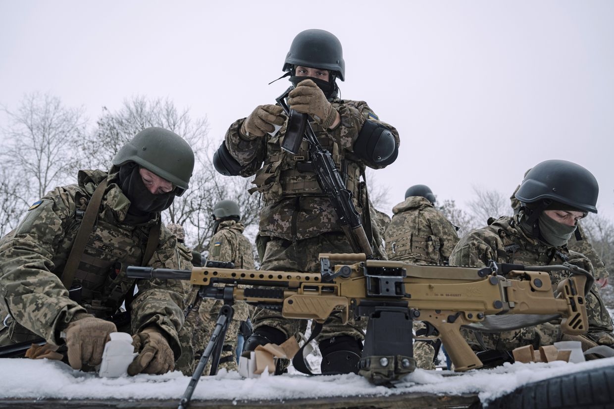Members of the Siberian Battalion prepare weapons during military exercises with the International Legion of the Armed Forces of Ukraine at an undisclosed location in Ukraine, in December 2023.
