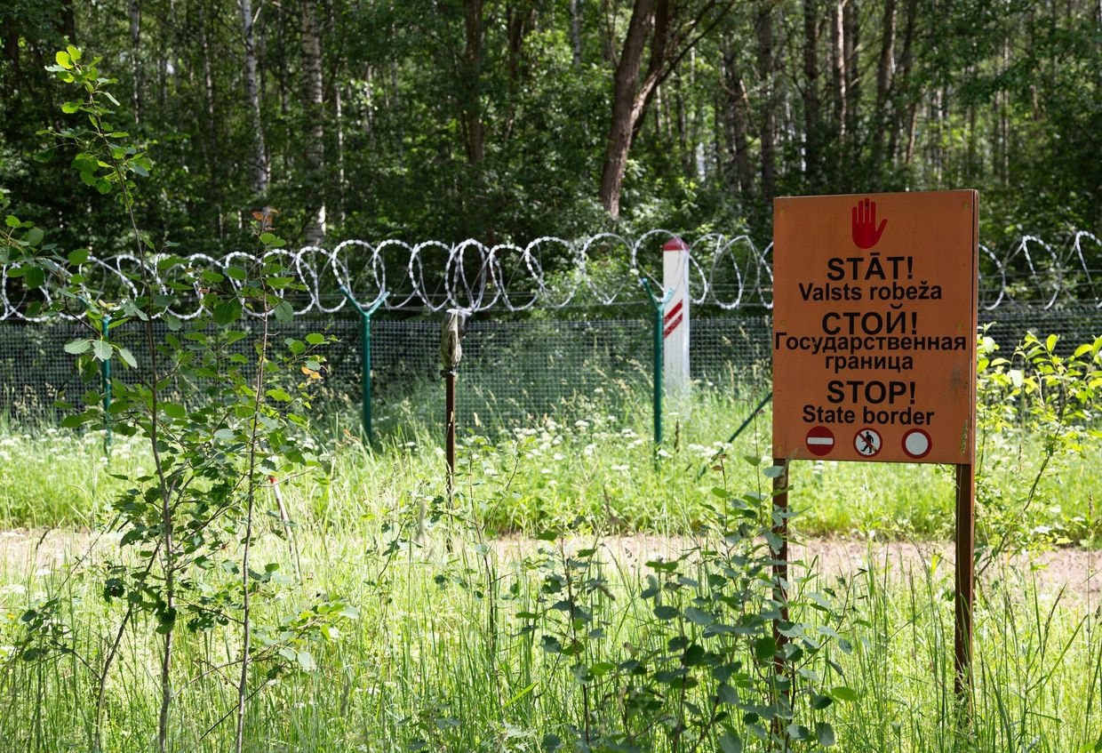 "Stop - state border" is written in three languages on a sign on the Latvian border with Russia on June 18, 2024. (Alexander Welscher/picture alliance via Getty Images)