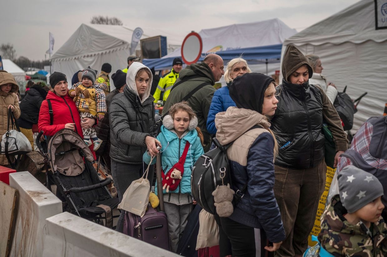 Ukrainian refugees wait for transport at the Medyka border crossing in Poland on March 29, 2022.
