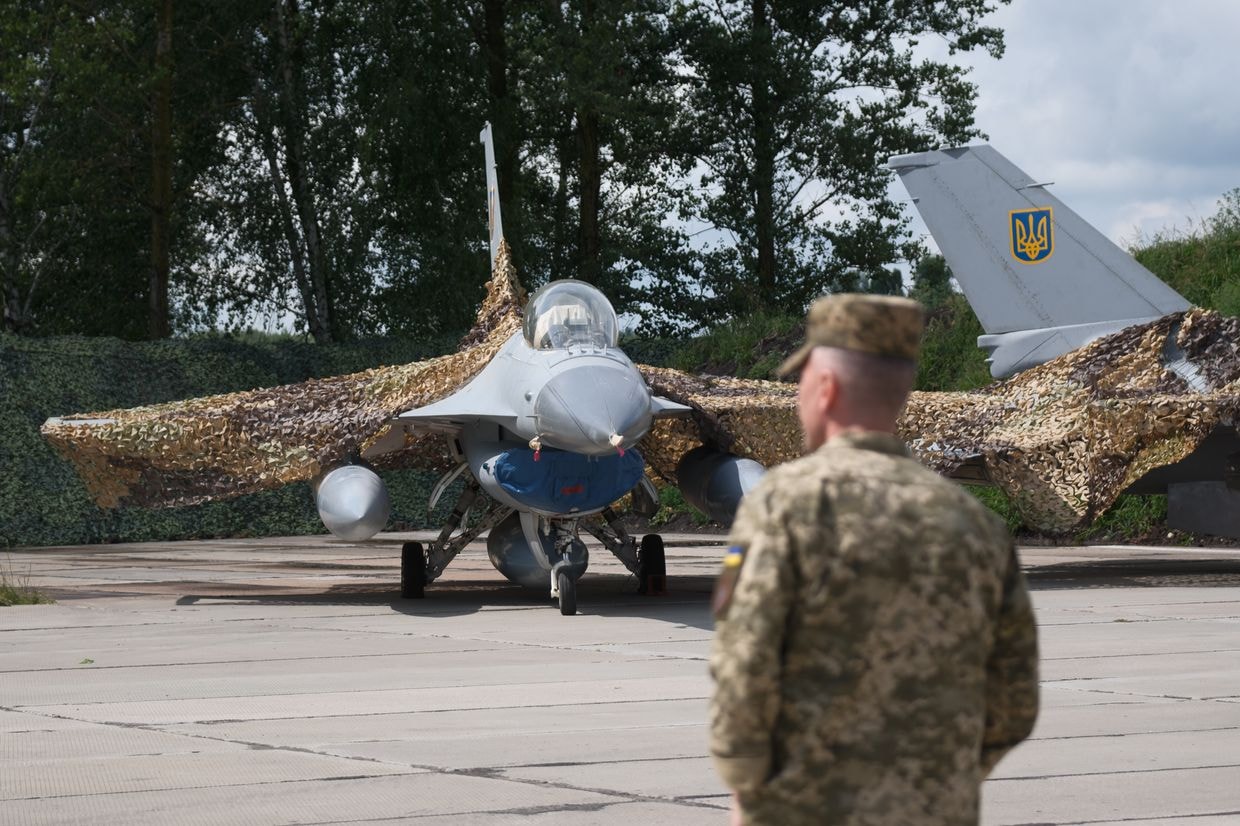 Ukrainian military stands next to the first General Dynamics F-16 Fighting Falcon received by Ukraine, on the Day of Ukrainian Air Force in Ukraine on Aug. 4, 2024. (Vitalii Nosach/Global Images Ukraine via Getty Images)