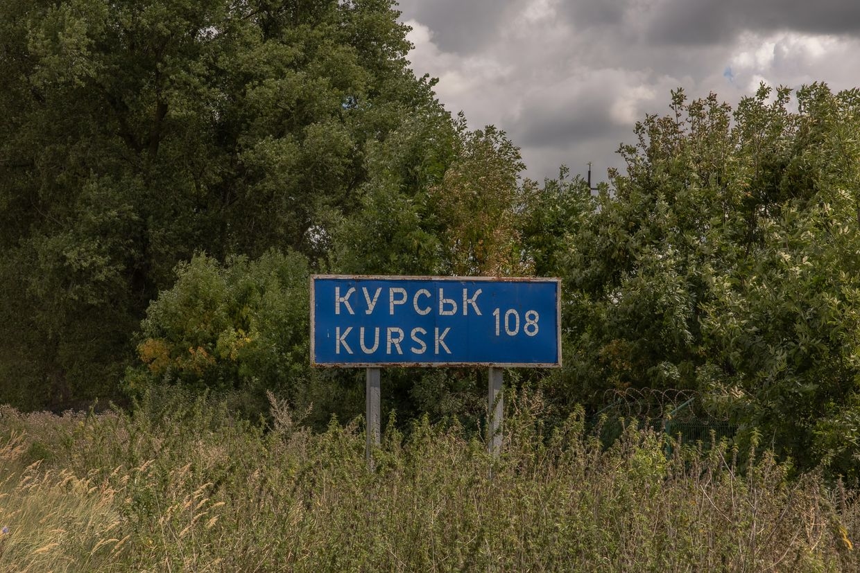 A road sign showing the distance to the Russian town of Kursk stands next to the destroyed border crossing point with Russia in Sumy Oblast, Ukraine, on Aug. 13, 2024.