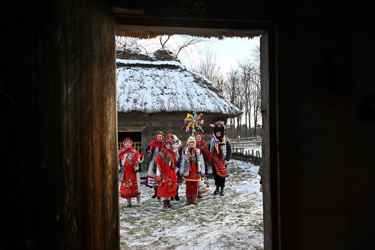 Children, wearing traditional Ukrainian outfits, sing Christmas carols during the festivities marking the Orthodox Christmas in Pirogovo village, not far from Kyiv, Ukraine, on Jan. 7, 2022.