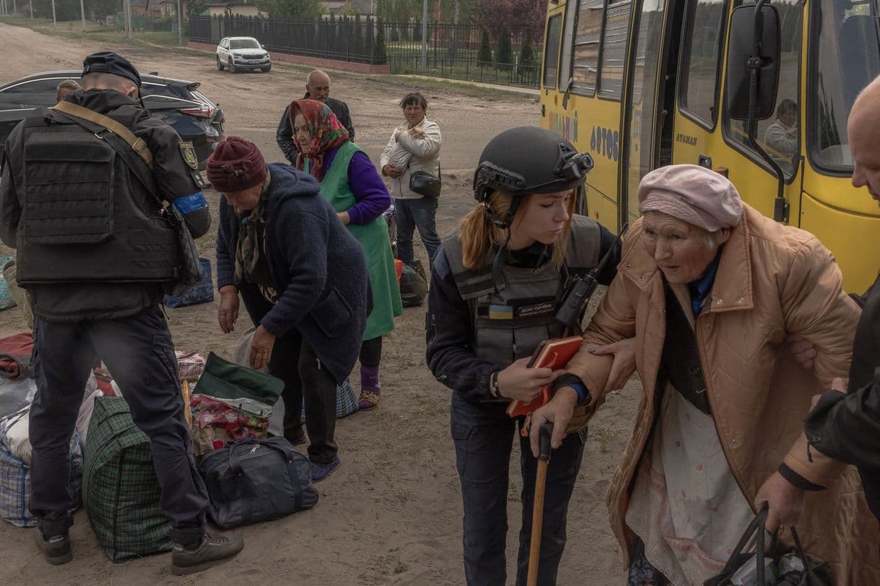 Evacuees arrive by bus at an evacuation point in Kharkiv Oblast, Ukraine, on May 12, 2024.