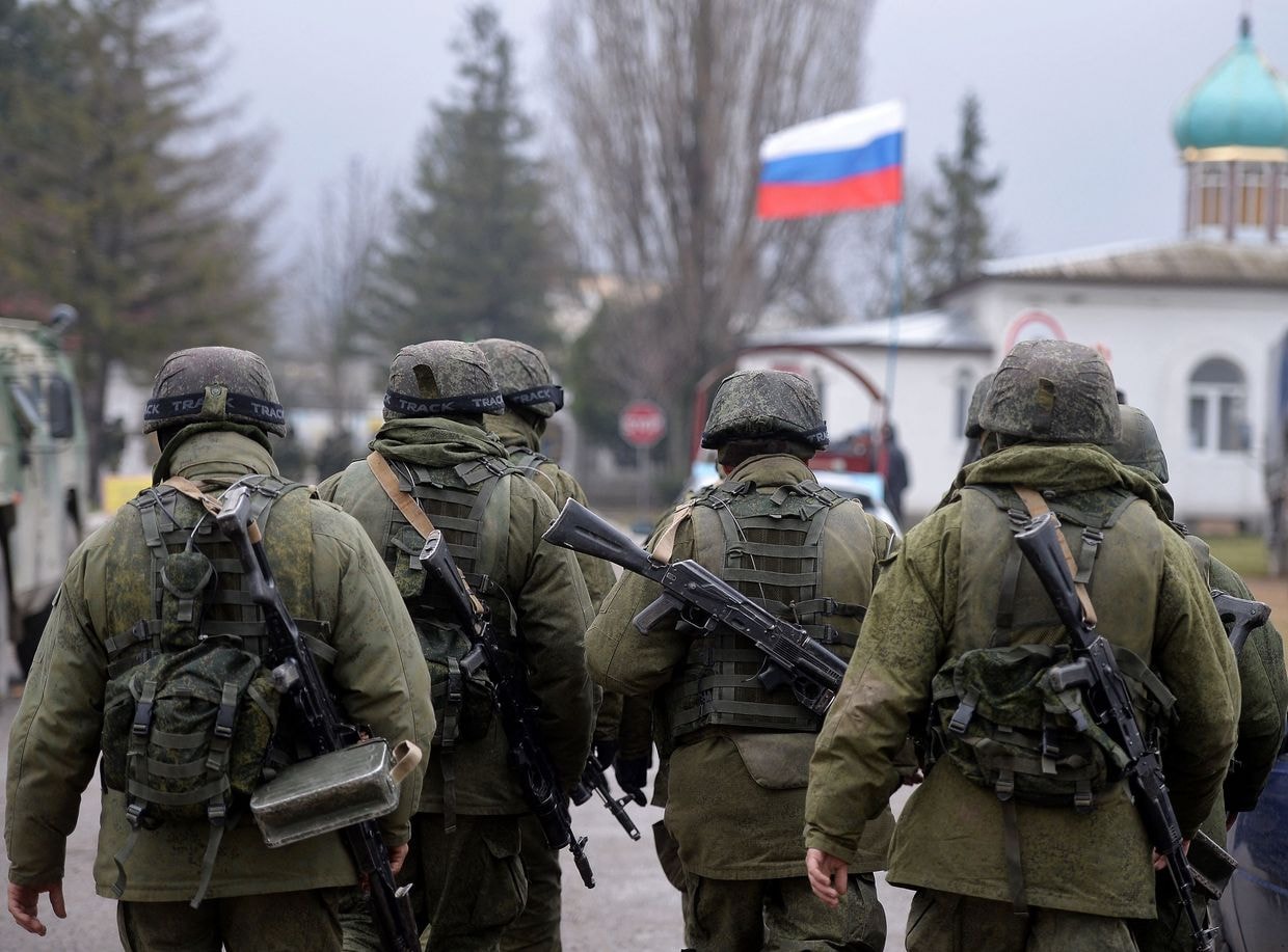 Russian soldiers patrol the area surrounding the Ukrainian military unit outside Simferopol, Crimea, on March 20, 2014. (Photo by Filippo Monteforte / AFP via Getty Images)