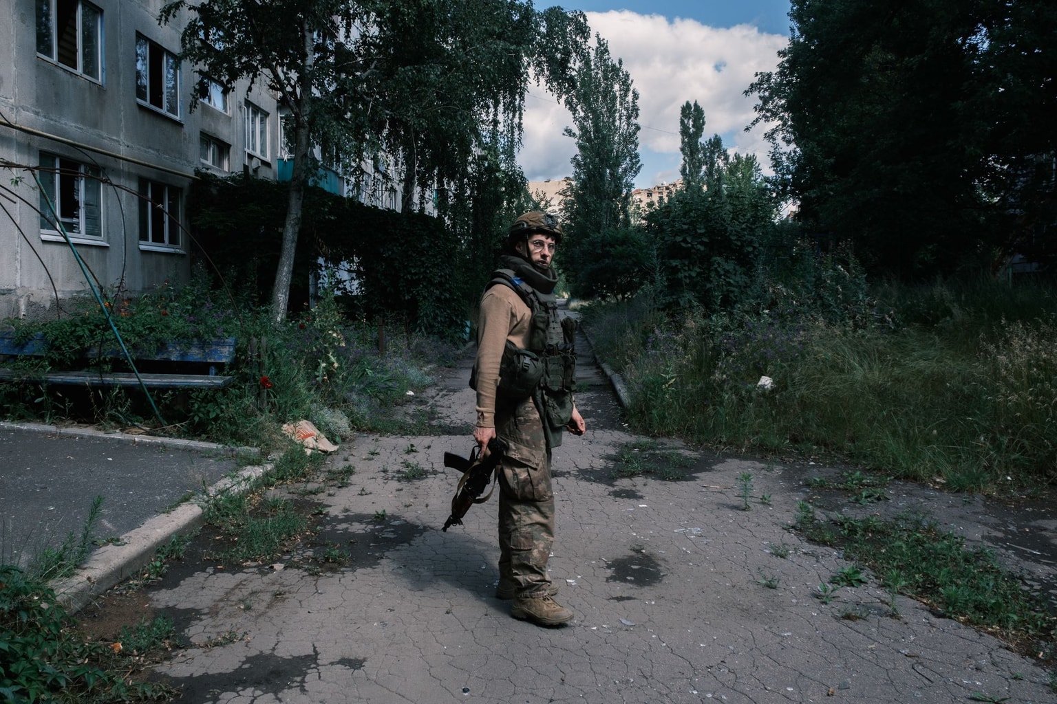 Ukrainian soldier Tadei "Teddy" walking inside the front-line city of Pokrovsk, Donetsk Oblast, on June 28, 2025. (Francis Farrell/The Kyiv Independent)