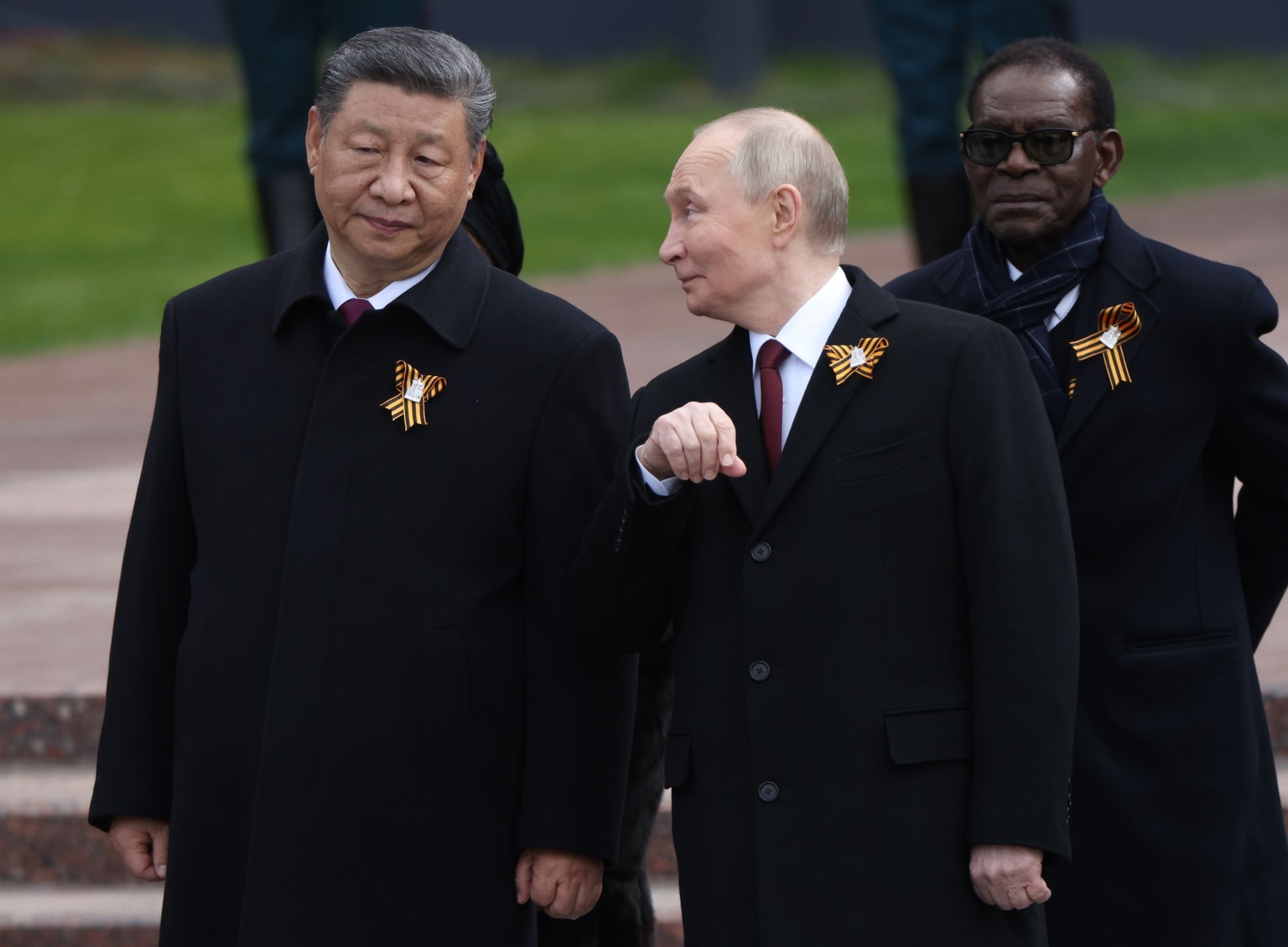 Russian President Vladimir Putin (C) speaks with Chinese President Xi Jinping (L) as President of Equatorial Guinea Teodoro Obiang Nguema Mbasogo (R) in Moscow, Russia, on May 9, 2025.