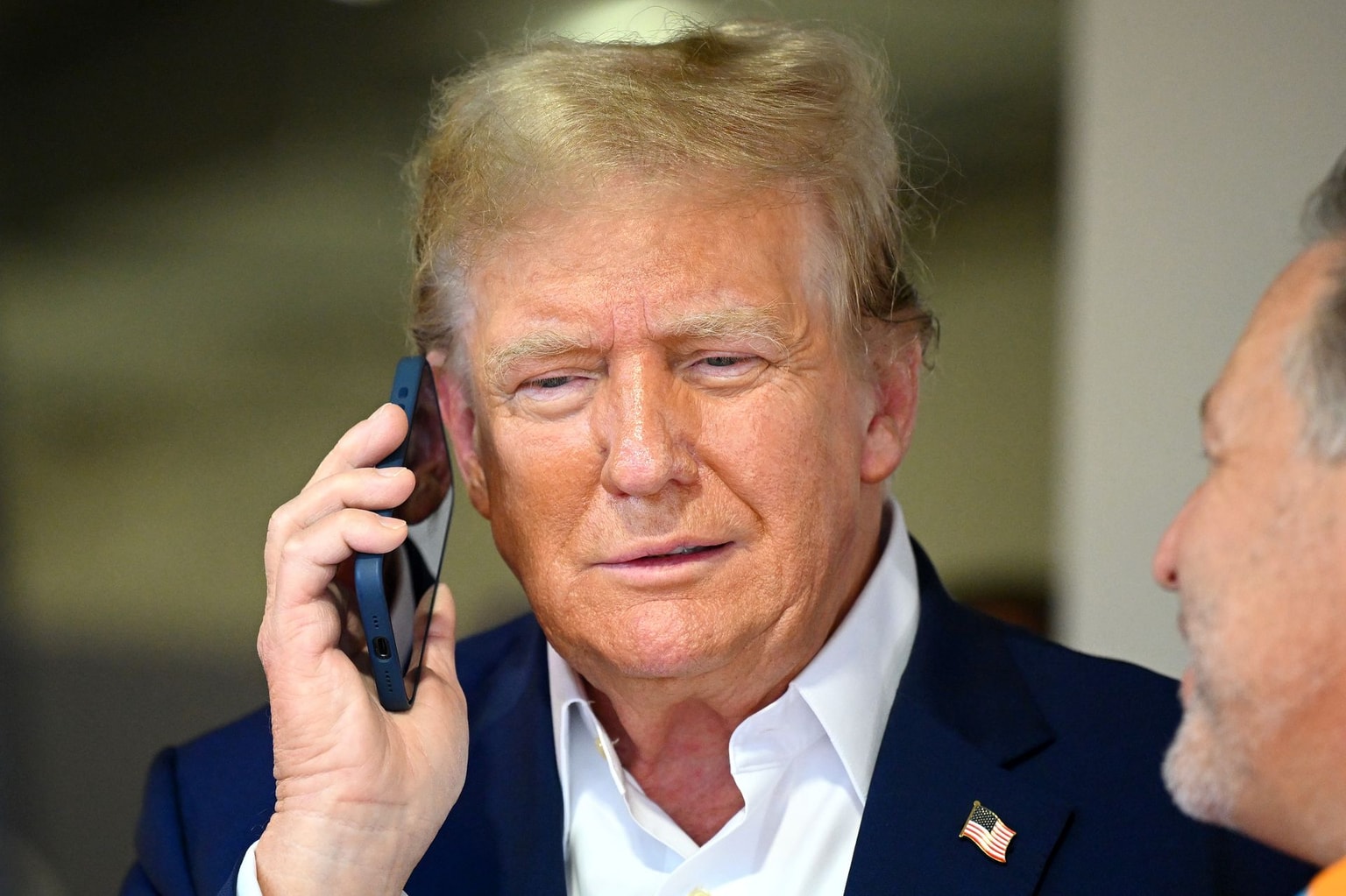 Donald Trump talks on the phone at Miami International Autodrome on May 05, 2024, in Miami, Florida. (Clive Mason/Getty Images)
