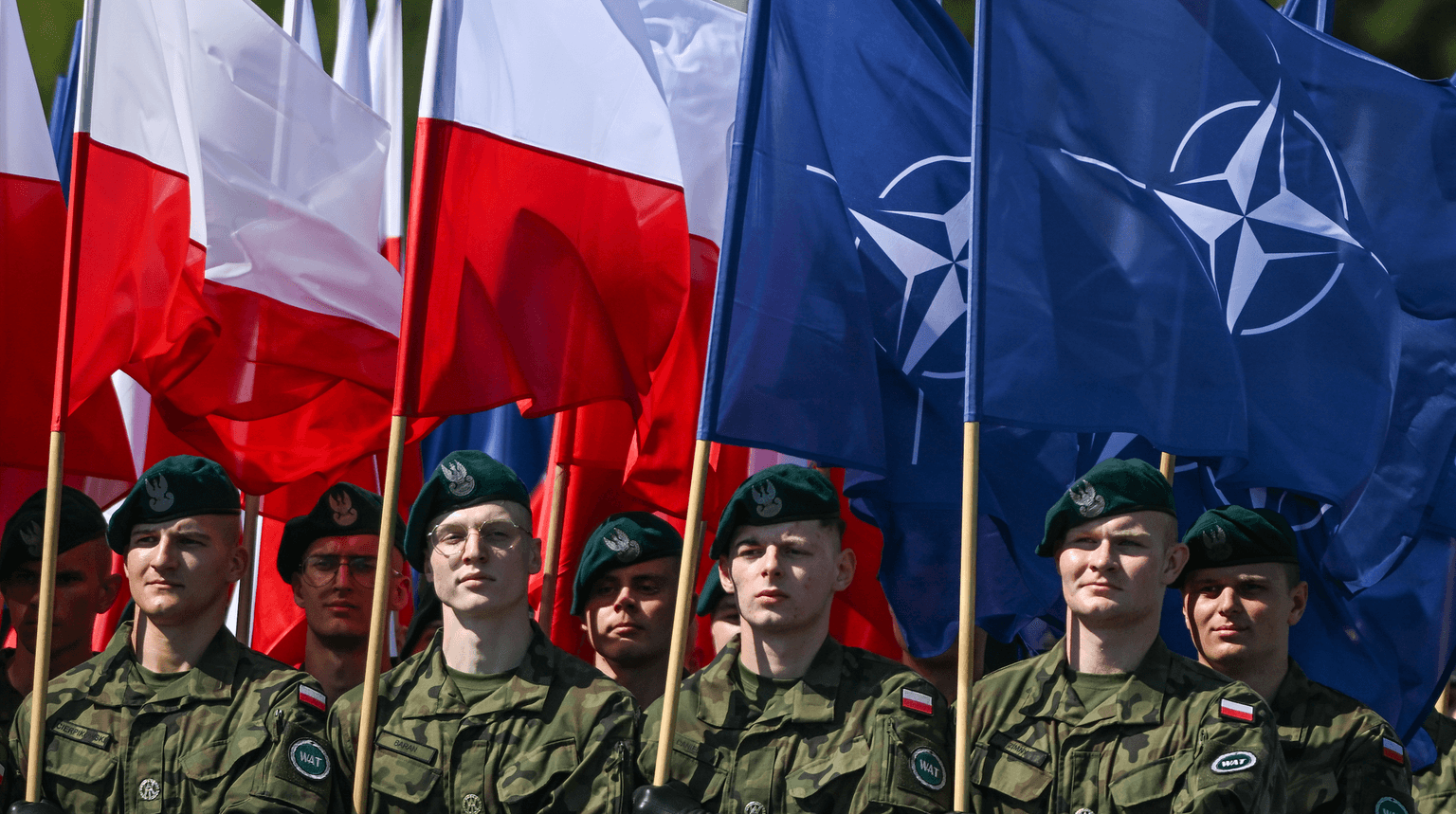 Soldiers from the Military University of Technology (WAT) carry the flags of the European Union, Poland, and NATO during the Armed Forces Day parade in Warsaw, Poland, on Aug. 15, 2025. (Artur Widak/NurPhoto via Getty Images)