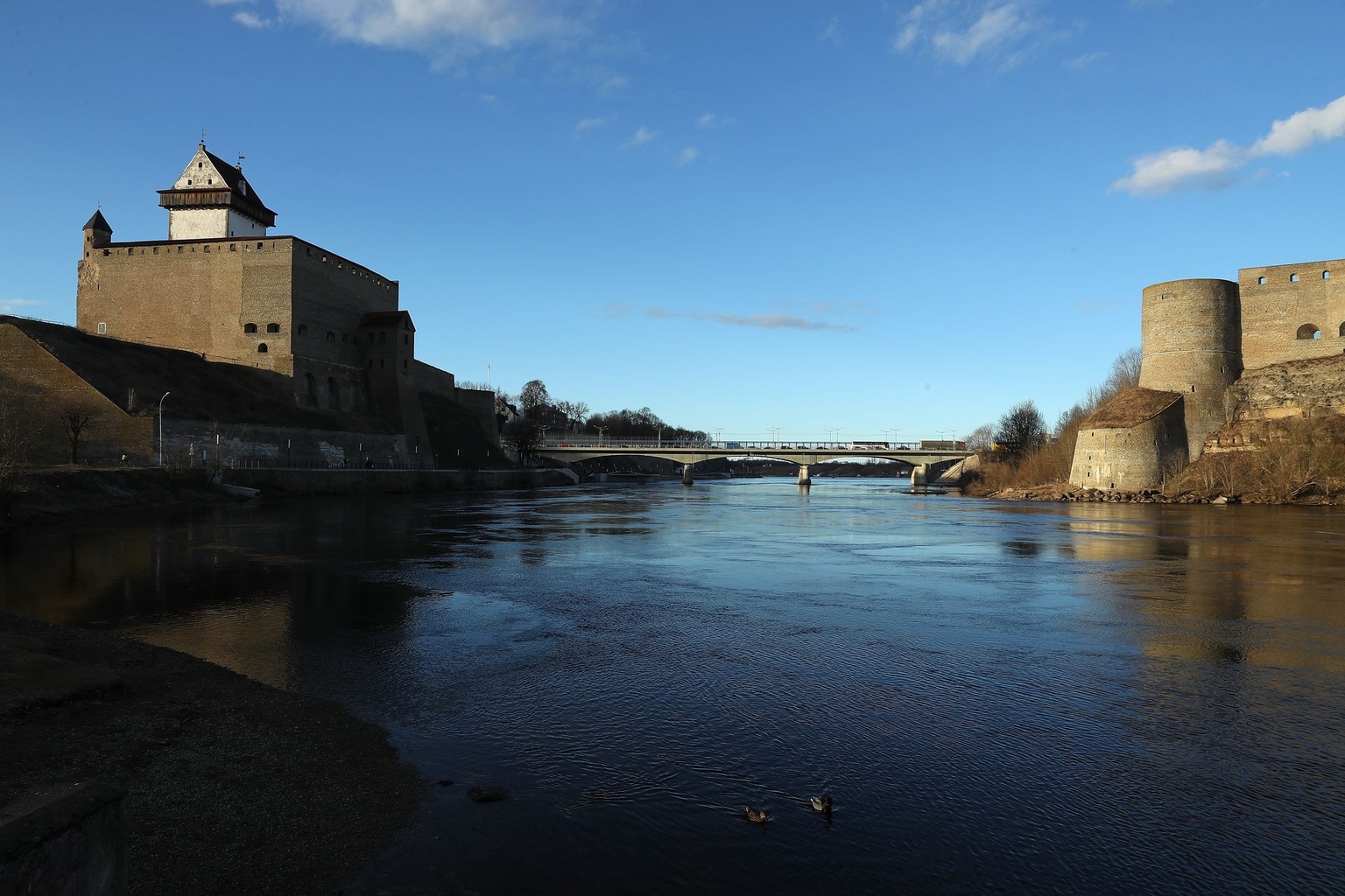 Narva River below Hermann Castle (L) and opposite Ivangorod Fortress (R) on the Russian side of the river, in Narva, Estonia, on March 23, 2017.