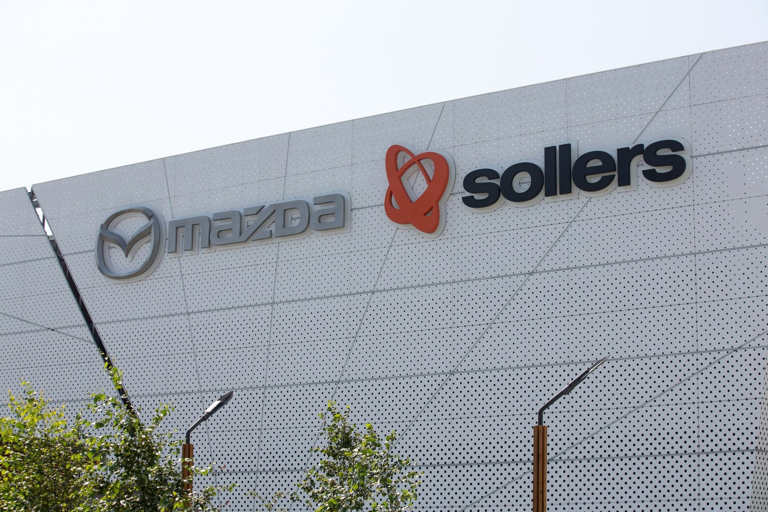 A Mazda Motor Corp. sign, alongside a Sollers PJSC sign in Vladivostok, Russia, on Sept. 3, 2019. (Andrey Rudakov/Bloomberg via Getty Images)