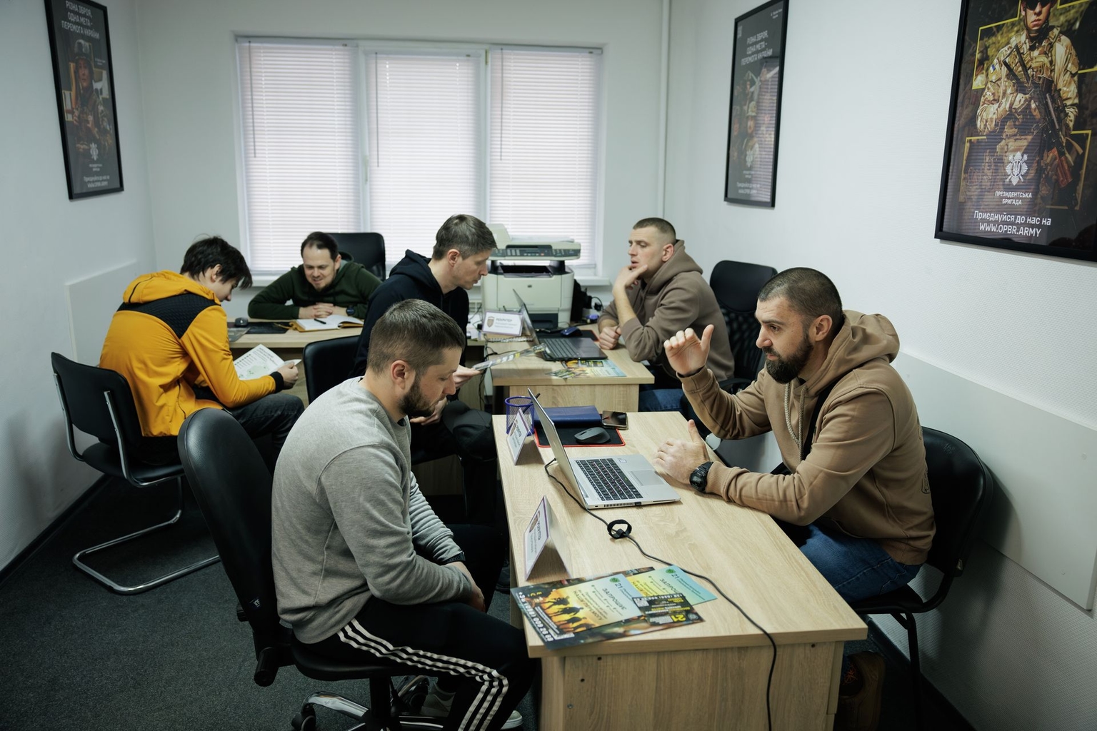 Men go through interviews during the opening of a recruitment center of the Separate Presidential Brigade in Kyiv, Ukraine, on March 1, 2025.