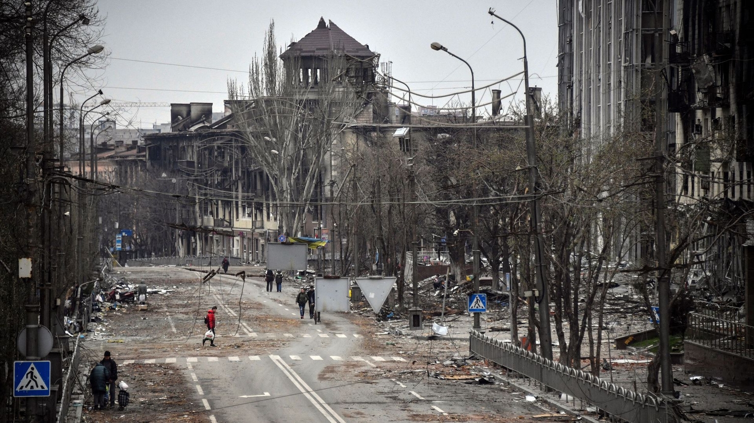 People walk down an avenue in Mariupol, Ukraine, on April 12, 2022