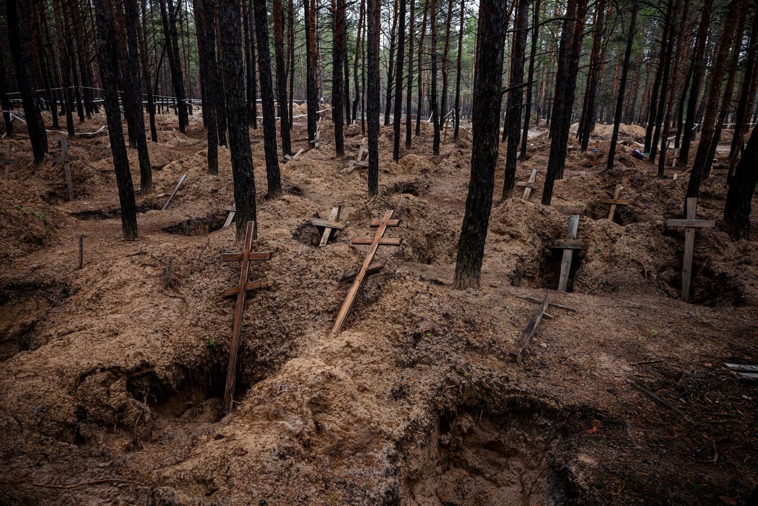 Empty graves after the exhumation of bodies from mass burial sites in Izium, Ukraine, on Nov. 4, 2022.