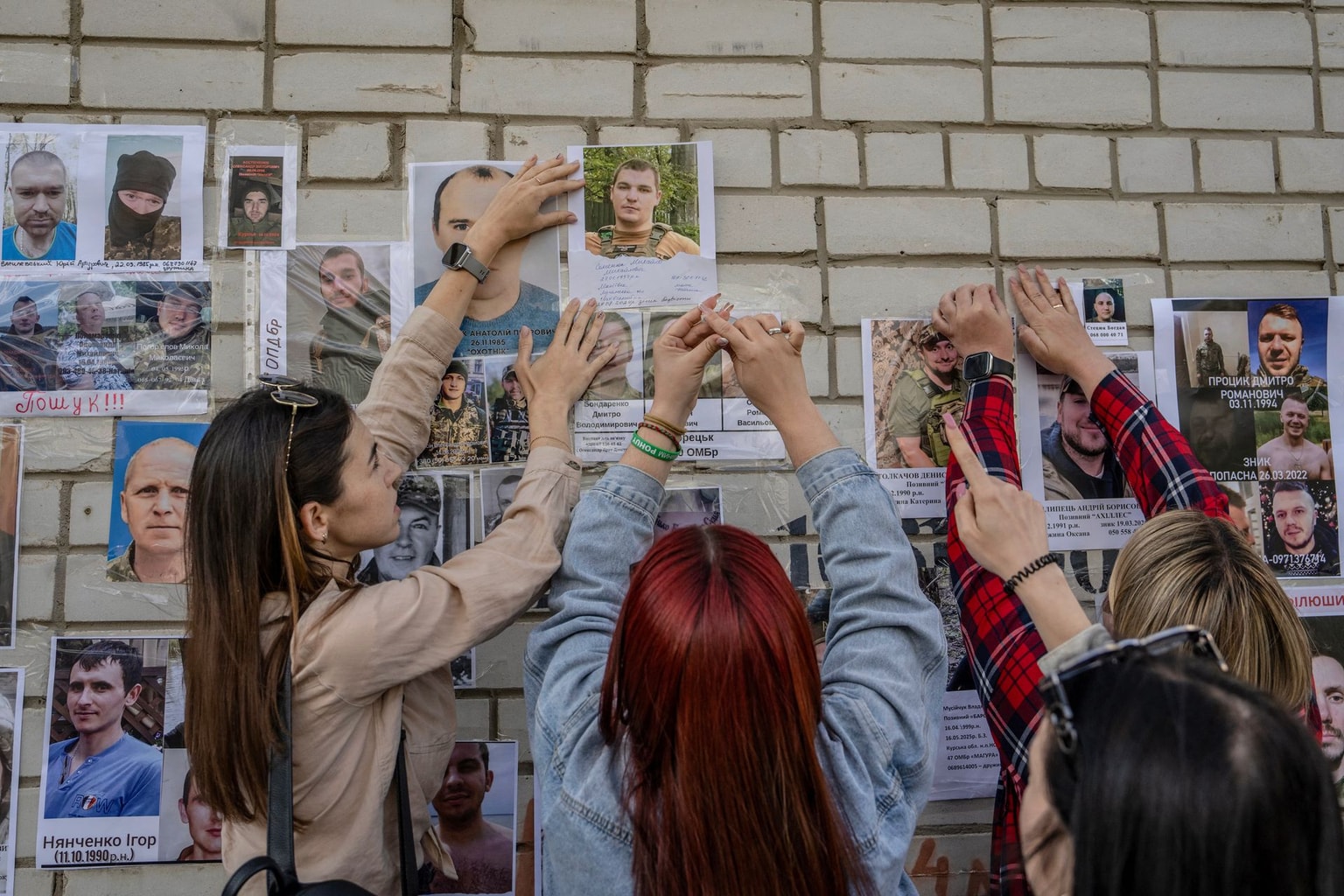 People put up portraits of missing or captured relatives and friends in Chernihiv Oblast, Ukraine, on June 10, 2025.