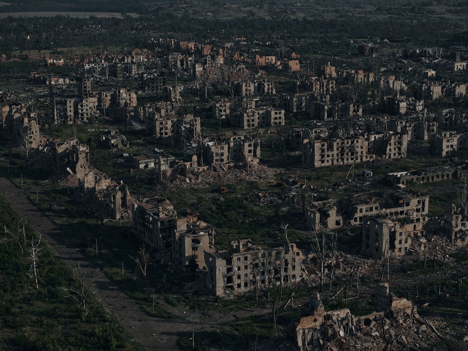 In an aerial view, the ruins of destroyed buildings are seen in the city of Chasiv Yar at dawn, as Russian forces continue a long-running campaign against the fortified eastern city.