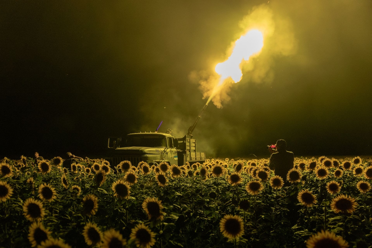Ukrainian servicemen from the 59th Brigade mobile air defense unit fire a Soviet-made ZU-23 anti-aircraft autocannon toward a Russian drone from a sunflower field during an air attack near Pavlohrad, amid Russia’s full-scale invasion of Ukraine.