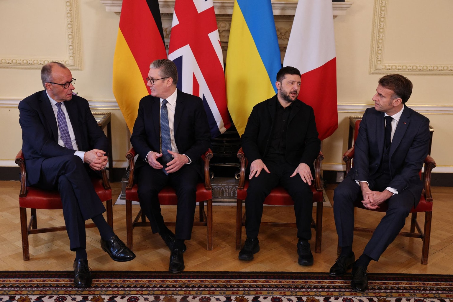 (L-R) Germany's Chancellor Friedrich Merz, British Prime Minister Keir Starmer, Ukraine's President Volodymyr Zelensky, and France's President Emmanuel Macron sit down ahead of a meeting inside 10 Downing Street in central London on Dec. 8, 2025. (Adrian Dennis / POOL / AFP via Getty Images)