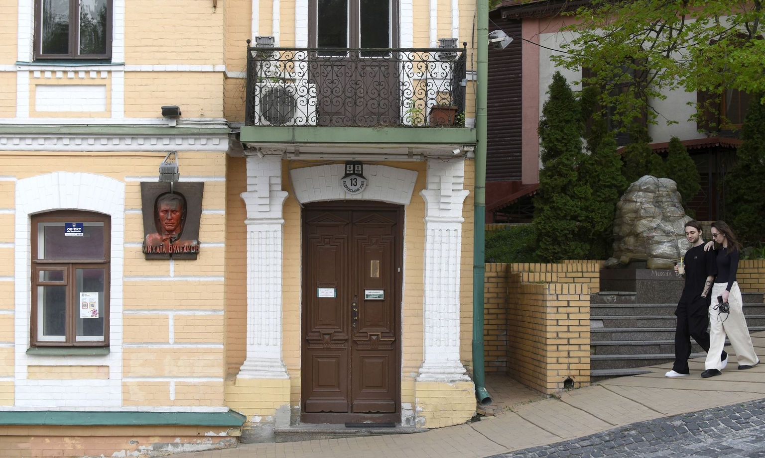 Red paint stains cover a memorial plaque to writer Mikhail Bulgakov on Andriivskyi Descent in Kyiv, Ukraine, on April 11, 2024.