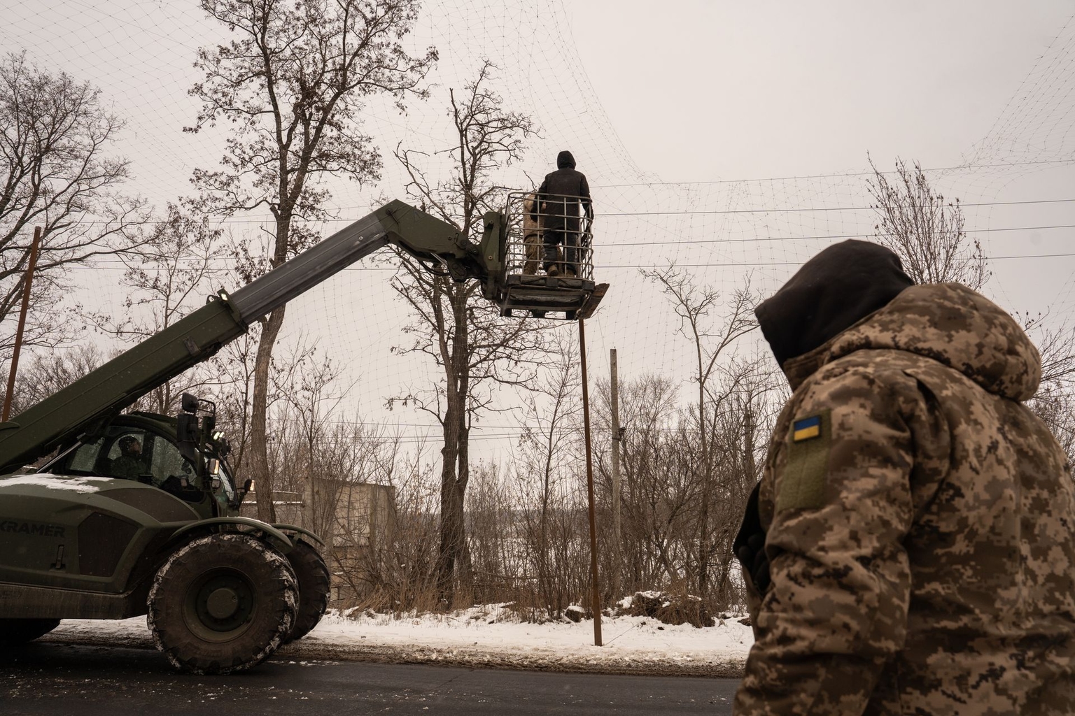Ukrainian soldiers set up anti-drone nets along a road in Donetsk Oblast, Ukraine, on Jan. 23, 2026.