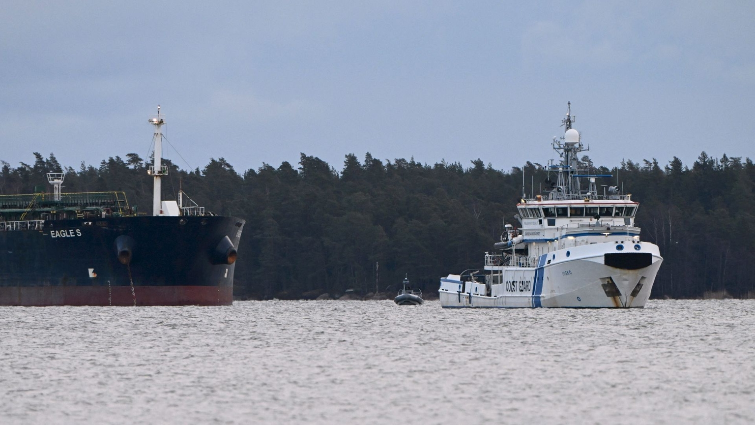 A vessel of the Finnish Coast Guard keeps watch on the oil tanker Eagle S anchored near the Kilpilahti port in Porvoo, Finland, on Dec. 30, 2024.