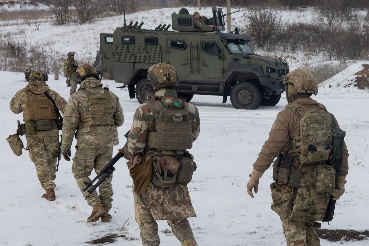 Ukrainian servicemen of the 18th Sloviansk Brigade of the National Guard of Ukraine walk near military equipment before a training at an undisclosed location in Donetsk Oblast on Jan. 28, 2026, amid the Russian invasion of Ukraine. (Tetiana Dzafarova / AFP)