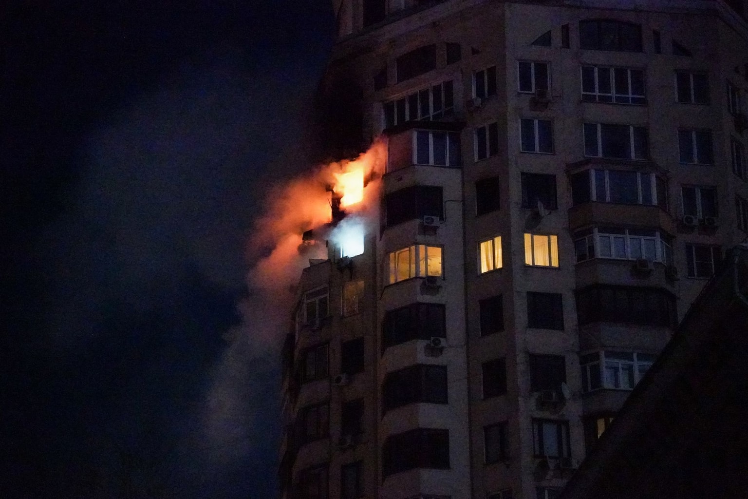 Fire is seen coming from an apartment building following a Russian air attack in Kyiv, Ukraine, early on Feb. 3, 2026.