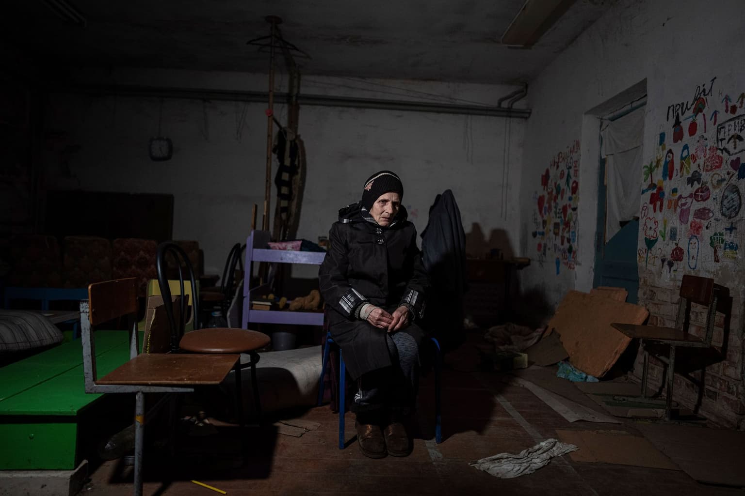 Valentina Saroyan sits in the basement of a school in Yahidne, Chernihiv Oblast, Ukraine, on April 12, 2022.