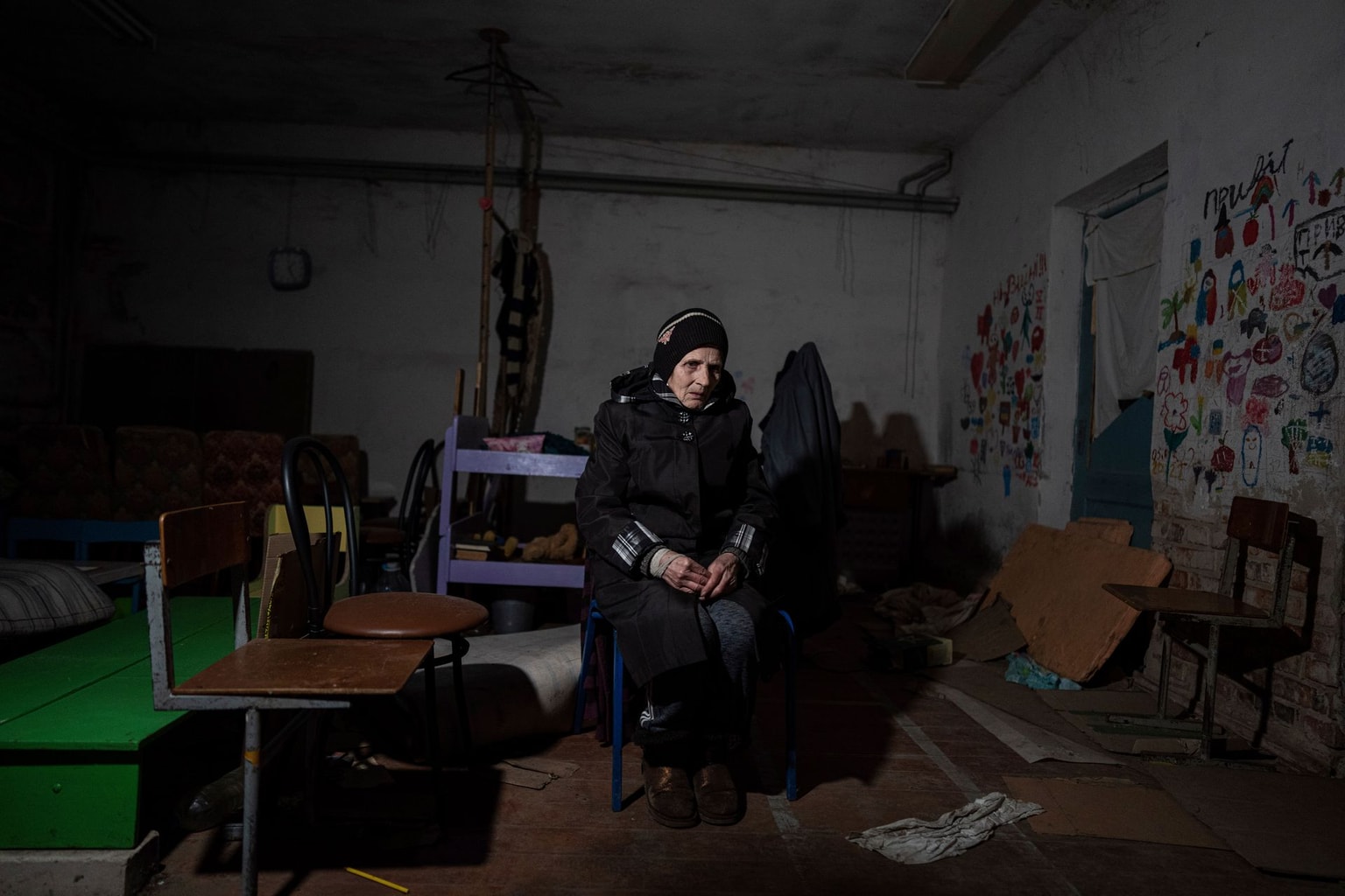 Valentina Saroyan sits in the basement of a school in Yahidne, Chernihiv Oblast, Ukraine, on April 12, 2022.