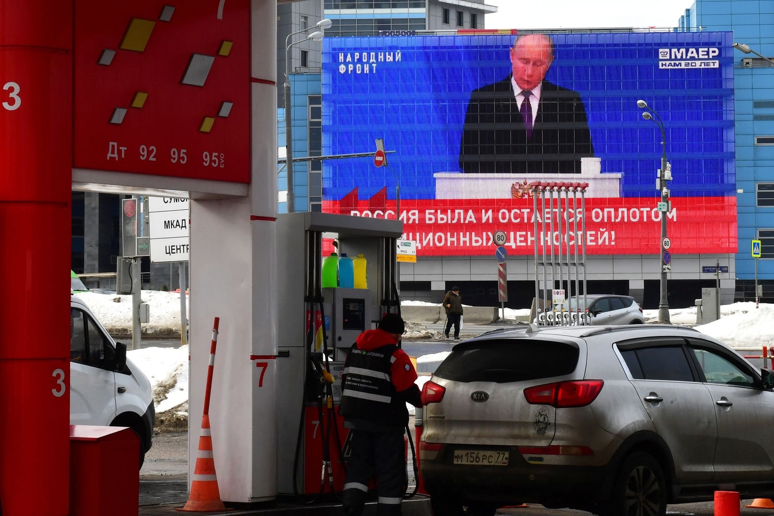 A screen displays the broadcast of Russian President Vladimir Putin's annual state of the nation address as an employee fuels a car at a gas station in Moscow, Russia, on Feb. 29, 2024. (Olga Maltseva / AFP via Getty Images)
