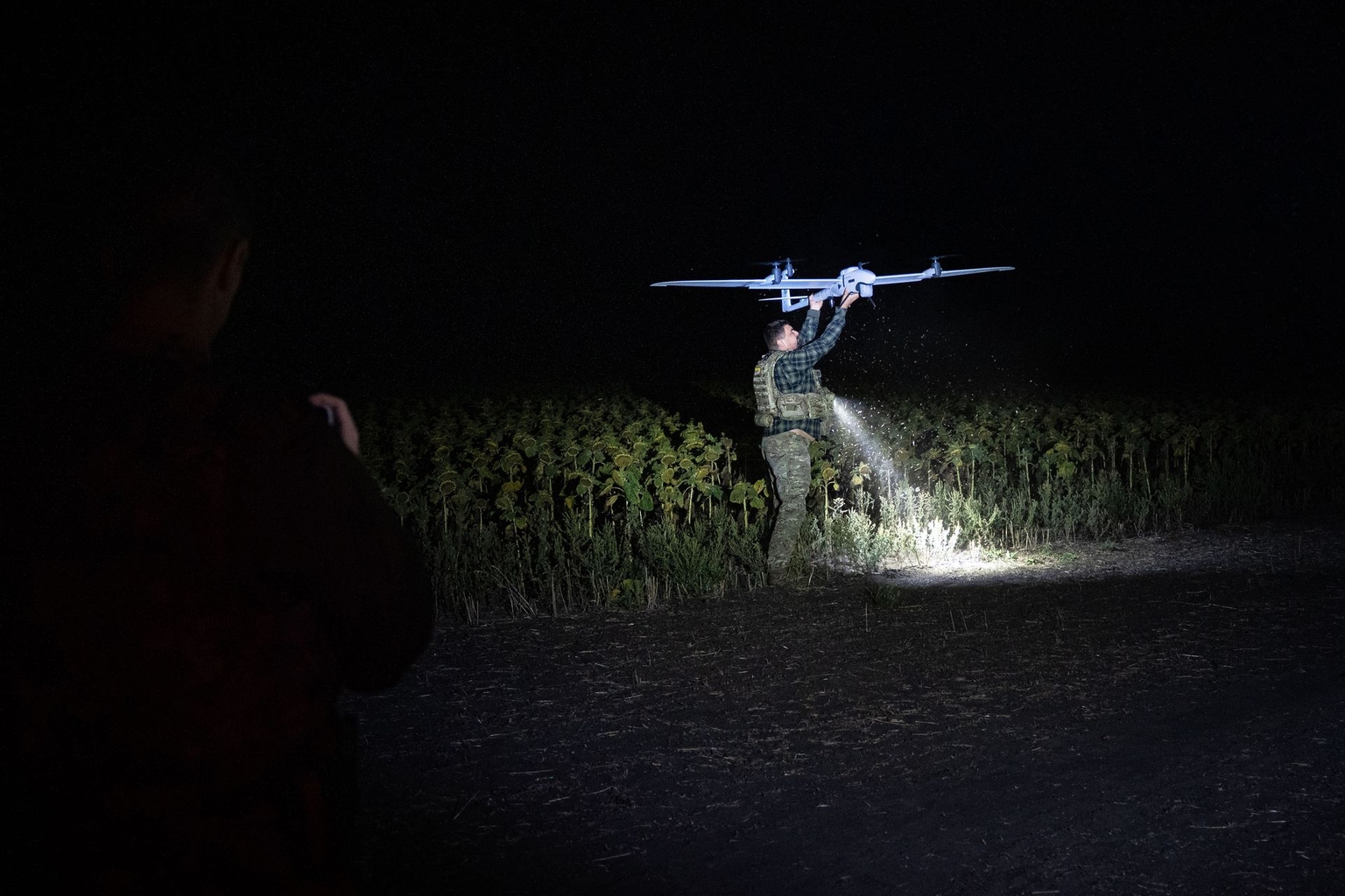 A member of the 1st Special Purpose "Safari" Assault Police Regiment handles a "Vector" reconnaissance drone during a mission in Donetsk Oblast, Ukraine, on Sept. 11, 2025.