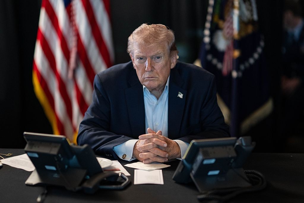 U.S. President Donald J. Trump sits at a table monitoring military operations during Operation Epic Fury against Iran, with U.S. flags visible behind him, in Washington, United States, on March 2, 2026. (The White House via X Account/Anadolu via Getty Images)