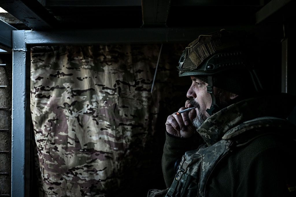 A soldier smokes a cigarette in a trench at a position near Zaporizhzhia, Ukraine, on Feb. 22, 2026. (Dmytro Smolienko/Ukrinform/NurPhoto via Getty Images)